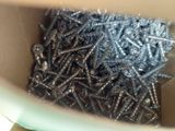 a lot of screws in a box on the table