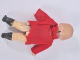 a small doll with a red dress and black boots