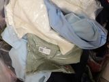 a pile of clothes in a plastic bag on the floor