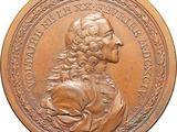 une image représentant une médaille de bronze sur laquelle figure un homme aux cheveux longs et à la barbe