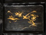 a black tray with a painting of birds and flowers on it