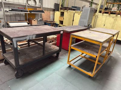 two tables that are sitting in the middle of a room