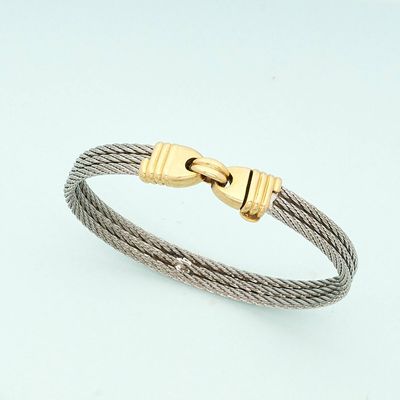 a close up of a cable bracelet with a gold clasp