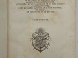 an old book with a black and white image of a coat of arms on top of it
