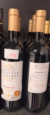 bottles of wine are lined up on a shelf in a store