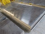 several pieces of steel are stacked on top of each other in a warehouse
