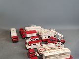 a lot of toy fire trucks that are on the floor