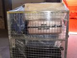 a cage with a mattress on top of it in a warehouse