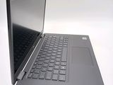 a laptop that is open on a white surface
