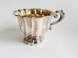an image of a silver cup on a white surface