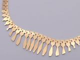 gold plated necklace with a large number of people on it