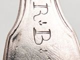 a silver spoon with the word eat written on it