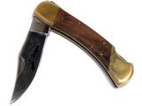 a knife with a wooden handle on a white surface