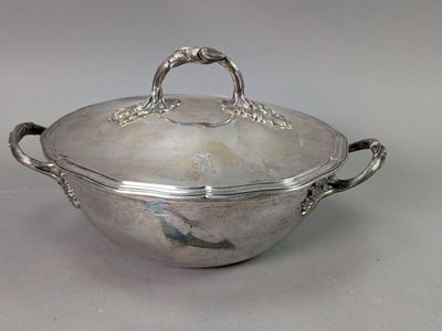 an antique silver plated casserole with handles and handles