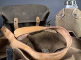 a bag and a flask sitting on top of a table