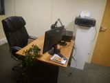 a desk with a computer and a printer on it