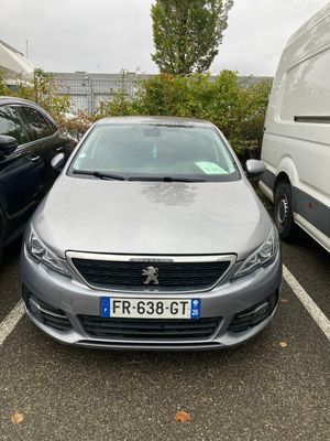 two cars parked in a parking lot next to each other