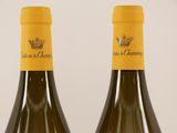 two bottles of wine sitting next to each other on top of a table