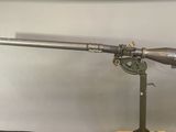 a gun that is on a stand on a table
