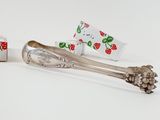 two spoons and a box of candy on a white surface