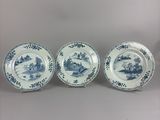 three blue and white plates with flowers and birds on them