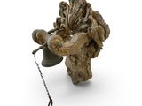 a statue of a bird holding a bell on a chain