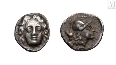 a close up of a coin with a face on it