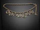 a gold necklace with the word ' changers ' written on it