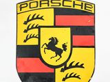 a close up of a porsche emblem on the side of a white car
