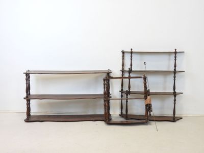 three wooden shelves are lined up against a wall in a room