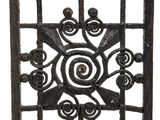 an old iron gate with a spiral design on it
