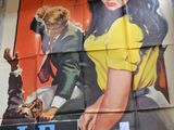 a large poster of a woman in a yellow shirt on a wall