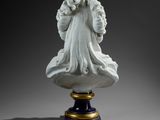 marble bust of a woman with flowing hair on a pedestal