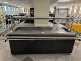a counter with a glass top in the middle of a room