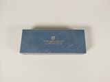 a close up of a blue case on a white surface