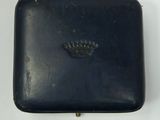 a black box with a crown on it on a white surface