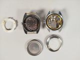 two watches that are sitting next to each other on a table