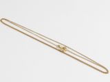 a gold chain necklace with a heart charm on a white background