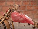 a red motorcycle with a red seat and a red handlebar