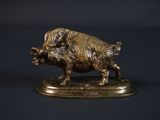figurine en bronze représentant un sanglier sur un socle, sur fond noir