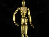 a close up of a gold figurine on a black background