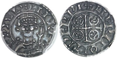 a close up of two silver coins on a white surface