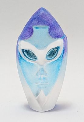 a blue and white vase with a face on it