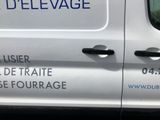 a white van with blue writing on the side of it