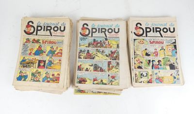 three old comic books sitting on top of each other on a table