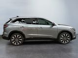 a silver suv parked in a room with a white wall
