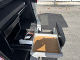 a small open drawer in the back of a van