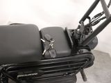 a black chair with a pair of scissors and a pair of scissors on it