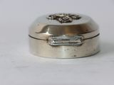 a small silver box sitting on a white surface