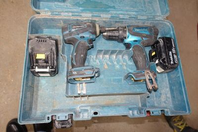 two power tools in a blue case on the floor